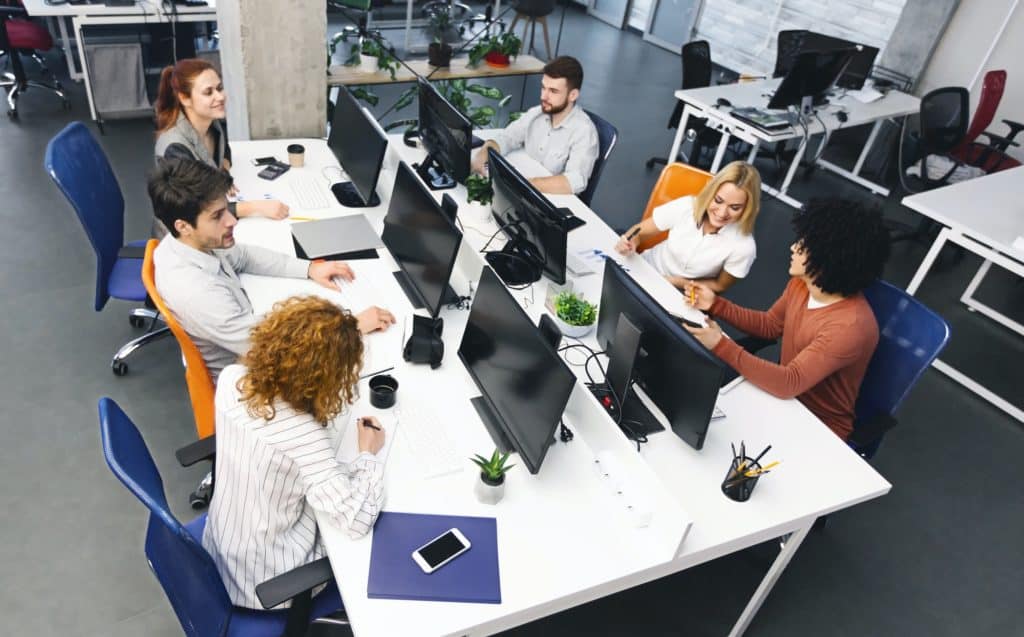 Group of young diverse people discussing project at workplace