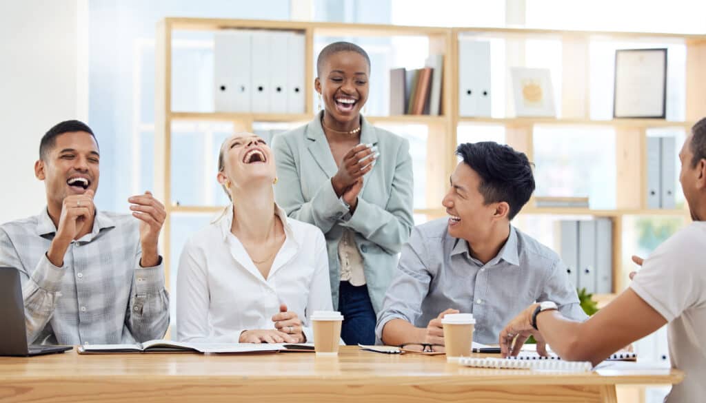 Business people, diversity and laughing in meeting at the office for funny team development at the